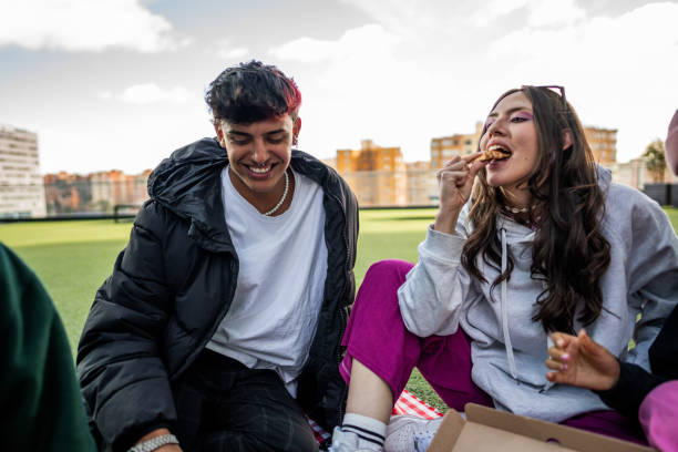 istock Friends having fun during a picnic at the rooftop 1583616473