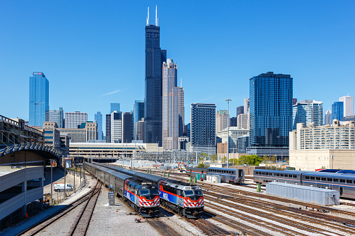 Chicago, United States - May 3, 2023: Skyline with METRA commuter rail trains public transport near Union Station in Chicago, United States.