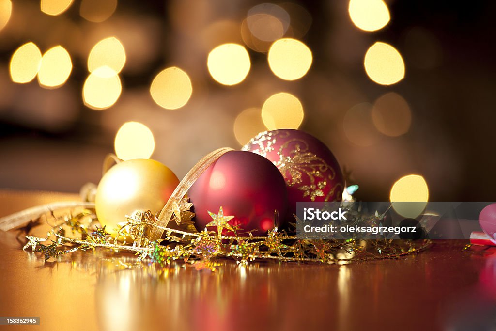 Christmas Balls Red and gold Christmas Balls against defocused background of Christmas lights Celebration Stock Photo