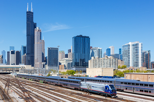 Chicago, United States - May 3, 2023: Skyline with Amtrak Midwest passenger train railway near Union Station in Chicago, United States.