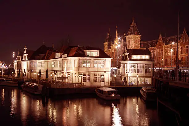 City scenic from Amsterdam with the central station at night in the Netherlands