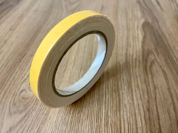 istock Double-sided adhesive on a wooden background. 1583680152