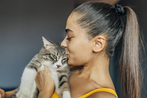 istock A young beautiful woman with her cat at home 1583723475