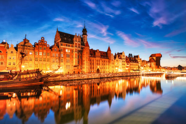 istock Illuminated Gdansk Old Town with Calm Motlawa River at Dusk, Poland 1583729310