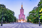 Illuminated Palace of Culture and Science with Fountain at Dusk in Warsaw
