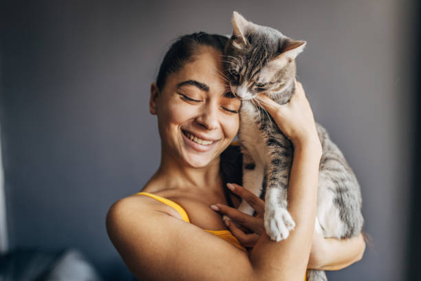 istock A young beautiful woman with her cat at home 1583731402