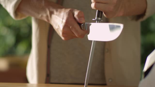 sharpening a knife in the knife sharpener