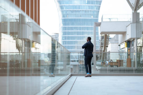 istock African American businessman in a modern environment looking and thinking 1583792470
