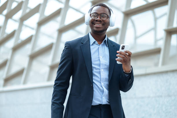 istock Happy African American man using modern technology on the street 1583804696