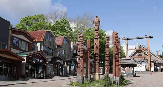 Akanko Onsen, Japan - June 5, 2023: Lake Akan Ainu Kotan is an Ainu village featuring Indigenous arts and crafts, live performances, and historic artifacts. Ainu artist Nuburi Toko carved Trees of the Spirits, or Kamuyni, completed in 2009. Spring morning in Akan National Park.