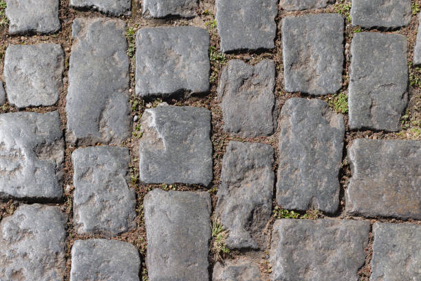 istock Photograph of old cobblestone pavement, with irregularly shaped cobblestones. 1583825484