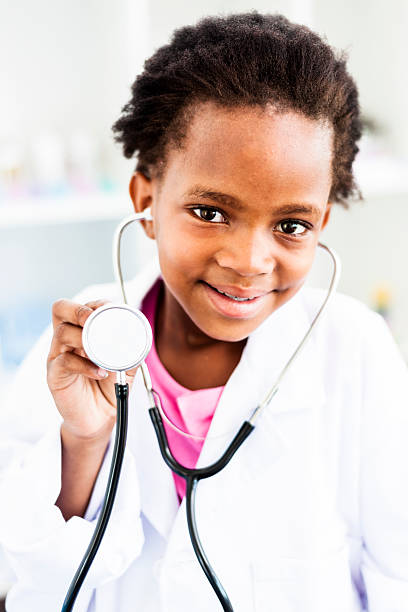 istock Little girl in doctors uniform with stethoscope 158385983