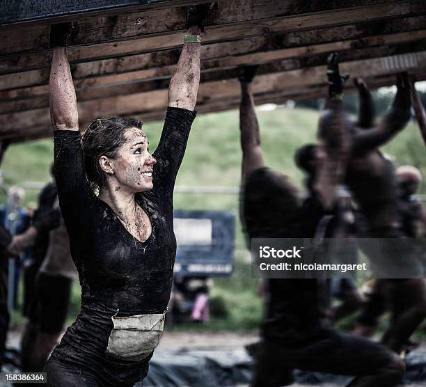 Female Athlete Competing In An Obstacle Course Stock Photo - Download Image Now - Obstacle Course, Conquering Adversity, Sports Race