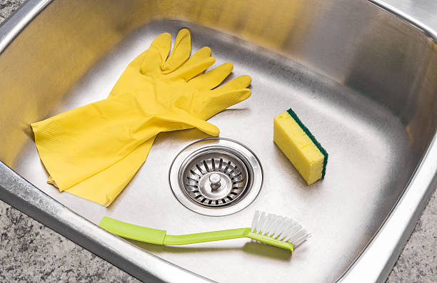 istock Gloves, sponge and brush in a clean kitchen sink 158392420