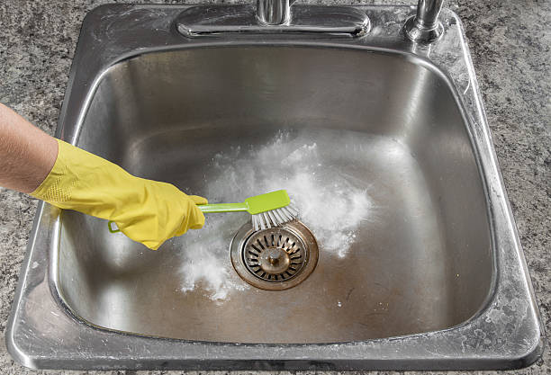 Cleaning the kitchen sink stock photo