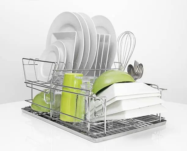 Photo of Bright dishes drying on metal dish rack