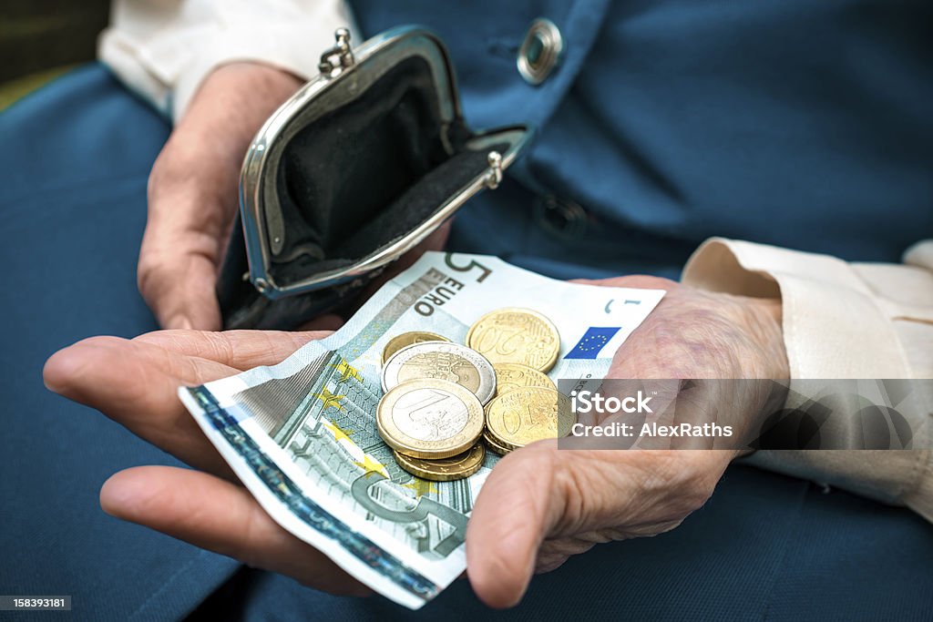 Senior woman counting money elderly caucasian woman counting coins in her hands Change Purse Stock Photo