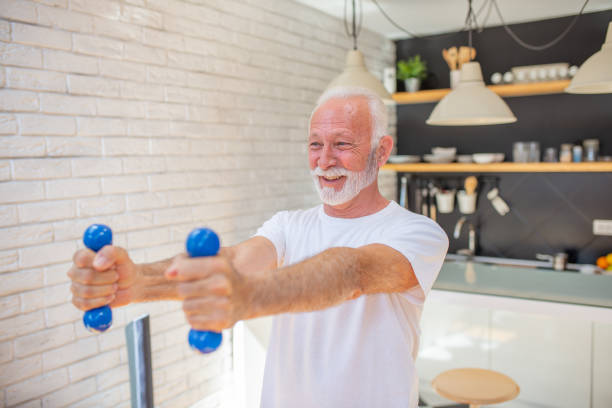 istock Senior man at home keeping fit by exercising 1583944134