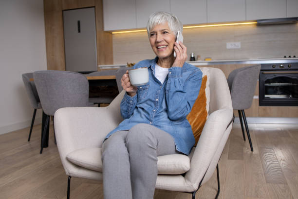 istock Happy senior woman using phone 1583954397
