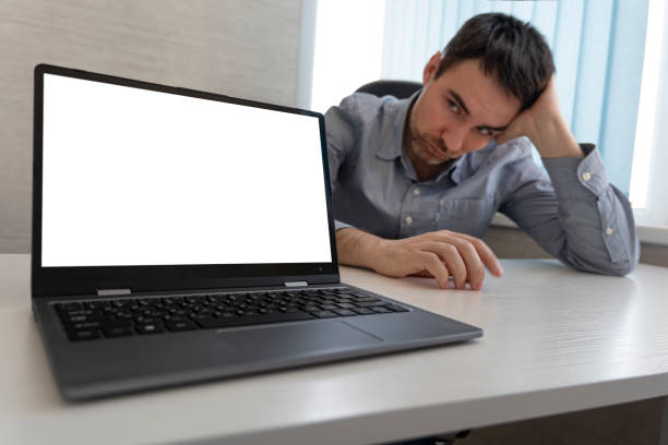 istock an empty white screen for text and design on a modern laptop standing in the workplace. Copy space. tired businessman in office. 1583954957
