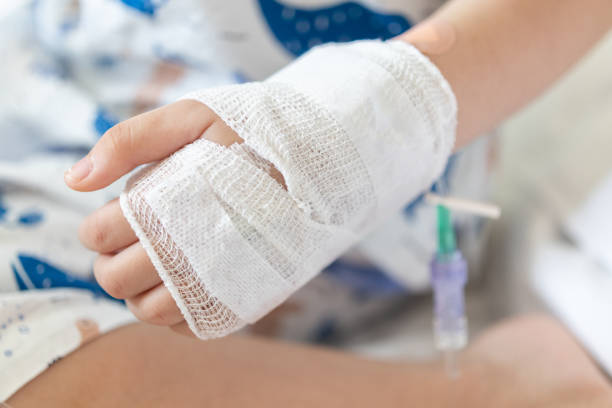 istock Close up child hand with saline IV solution in hospital 1583959726