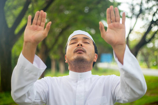 istock muslim man praying to Allah at park. 1583961358