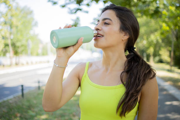 istock Young woman is jogging outside 1583965294