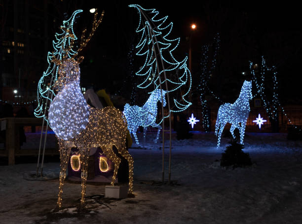 istock Beautiful illuminated background with Christmas decorations on the streets at night during holidays. Winter holiday background with selective focus 1584007768