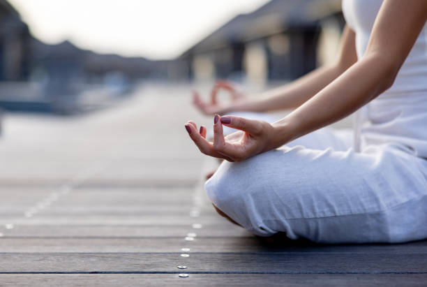 istock Woman meditating outdoors on the deck 1584019740
