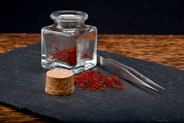 istock saffron with glass jar and tweezers 158402280