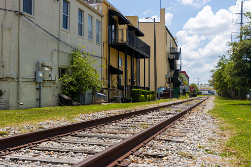 Train tracks run behind buildings in a small downtown.