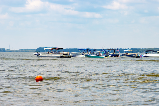 Recreational boats floating on a lake in the summer.