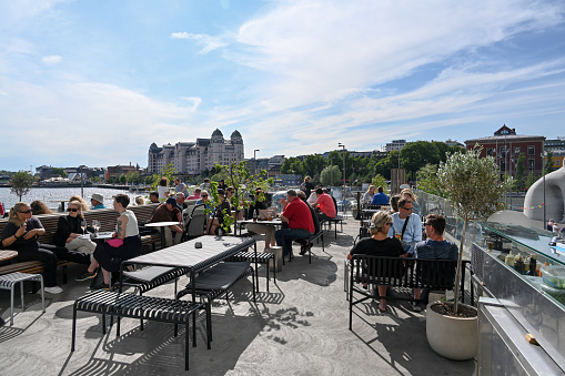 The Centropa rooftop bar at Oslo's new main library, Deichman Bjørvik, with the Havnelageret building in the background.