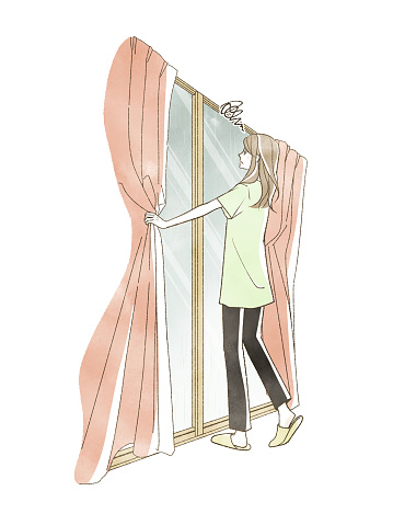 A woman opening the curtains and looking outside on a rainy day