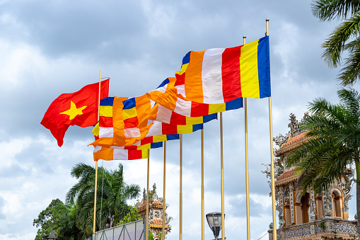 Buddhist flags mixed with Vietnamese flags in Vinh Trang pagoda, My Tho city, Tien Giang province