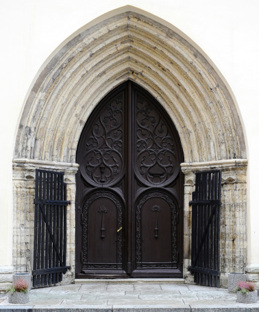 An open double-leaf church door in Valencia, Spain