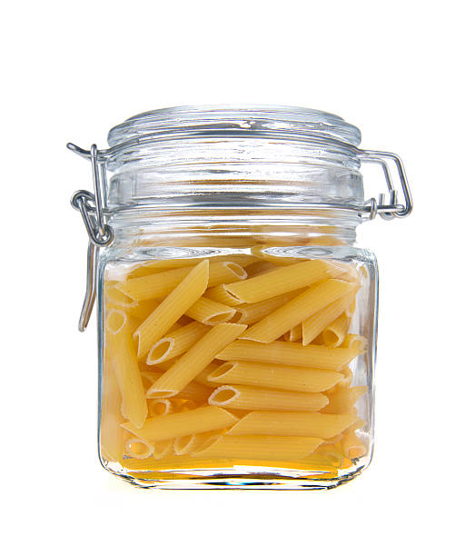 istock Macaroni in glass jar on a white background 158416975
