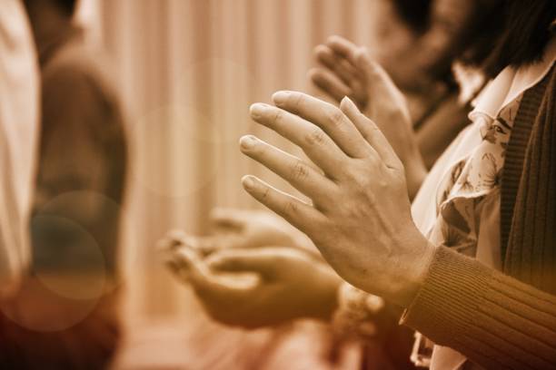 istock Human hand praying rising together at Church. 1584220818