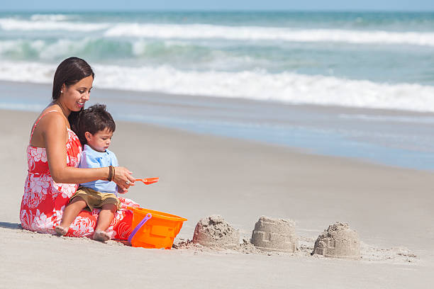 istock Hispanic Mother and Child Boy Son Playing At Beach 158422351