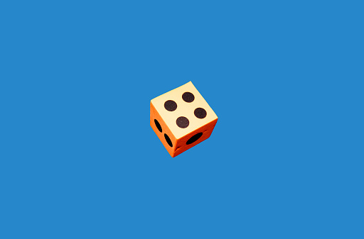 An orange foam dice on a blue background