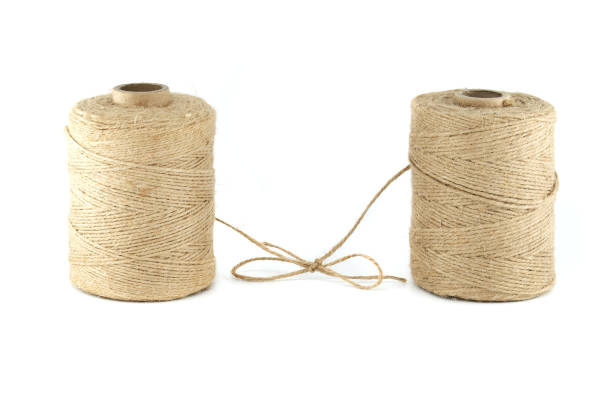 Pair of natural brown twisted jute twine spools isolated on white background