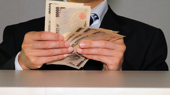 Photo of a businessman counting banknotes