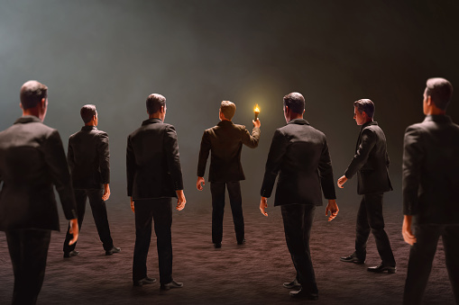 Businessman standing holding fire torch on dark background 3d illustration