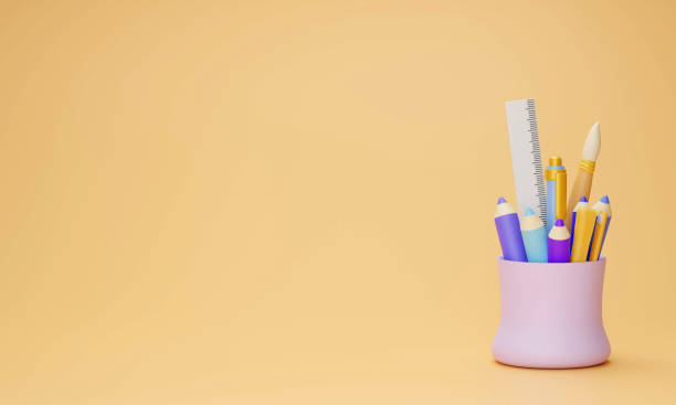 istock Colored pencils, ruler in basket isolated on yellow background. 1584300560