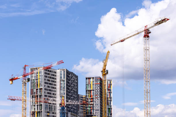 istock Tower cranes near the residential building 1584325377
