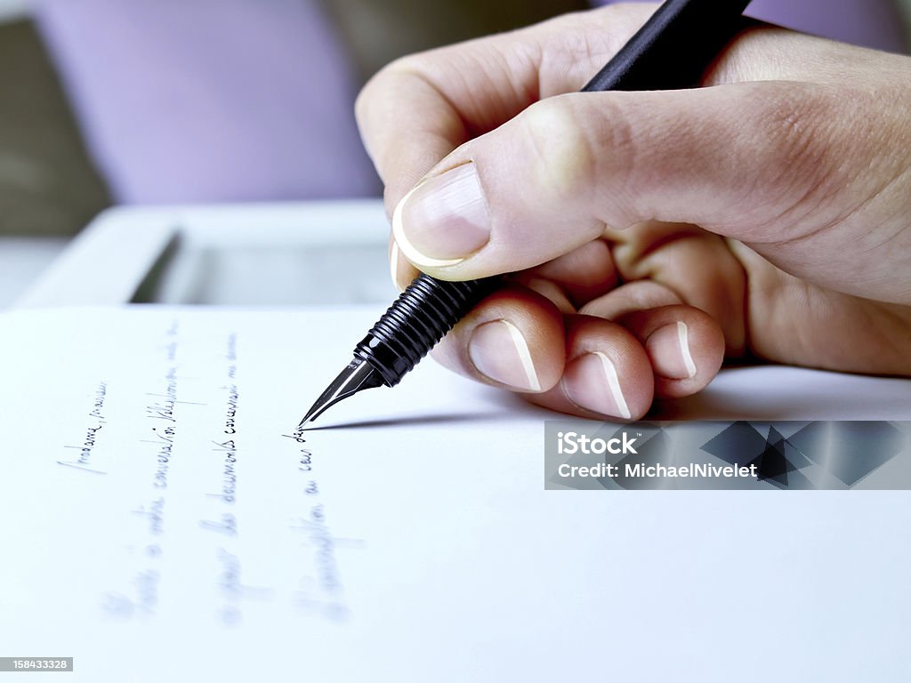 Handwriting Photography closeup of the hand of a woman about to write Adult Stock Photo