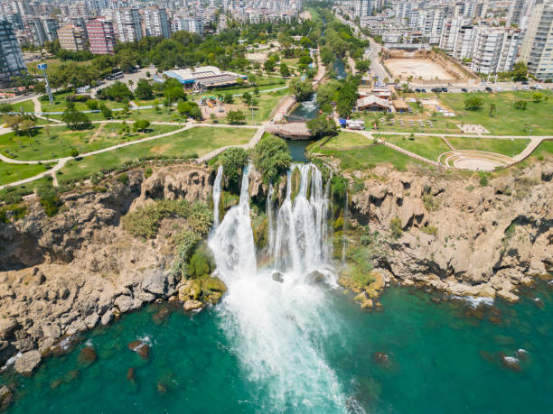 Aerial view of Duden waterfall dropping in Mediterranean Sea. Aerial view of Duden waterfall dropping in Mediterranean Sea in Antalya, Lara Antalya in a bright sunny day, Lower Duden Waterfalls,  the waterfall in the city falls into the sea, Turkey's famous tourism destination in Antalya. Duden stock pictures, royalty-free photos & images