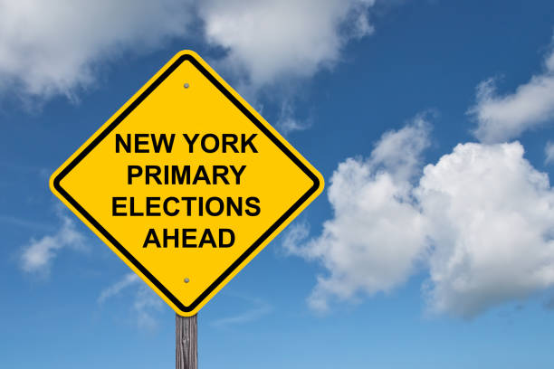 istock New York Primary Elections Ahead Caution Sign - Blue Sky Background 1584344115