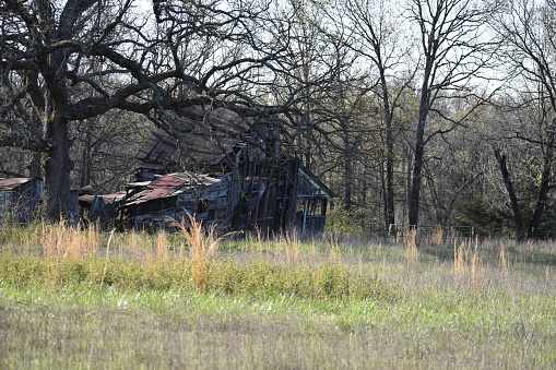 An old abandoned building on a cattle farm in Missouri, MO, United States, US, USA, is slowing falling down as it surrenders to time and the elements.