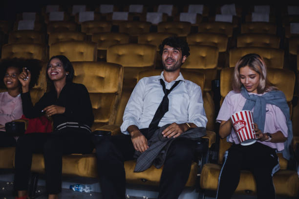 istock Group of audiences is watching a movie gleefully. 1584366519